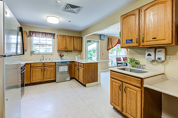 A spacious kitchen with wooden cabinets and modern appliances.