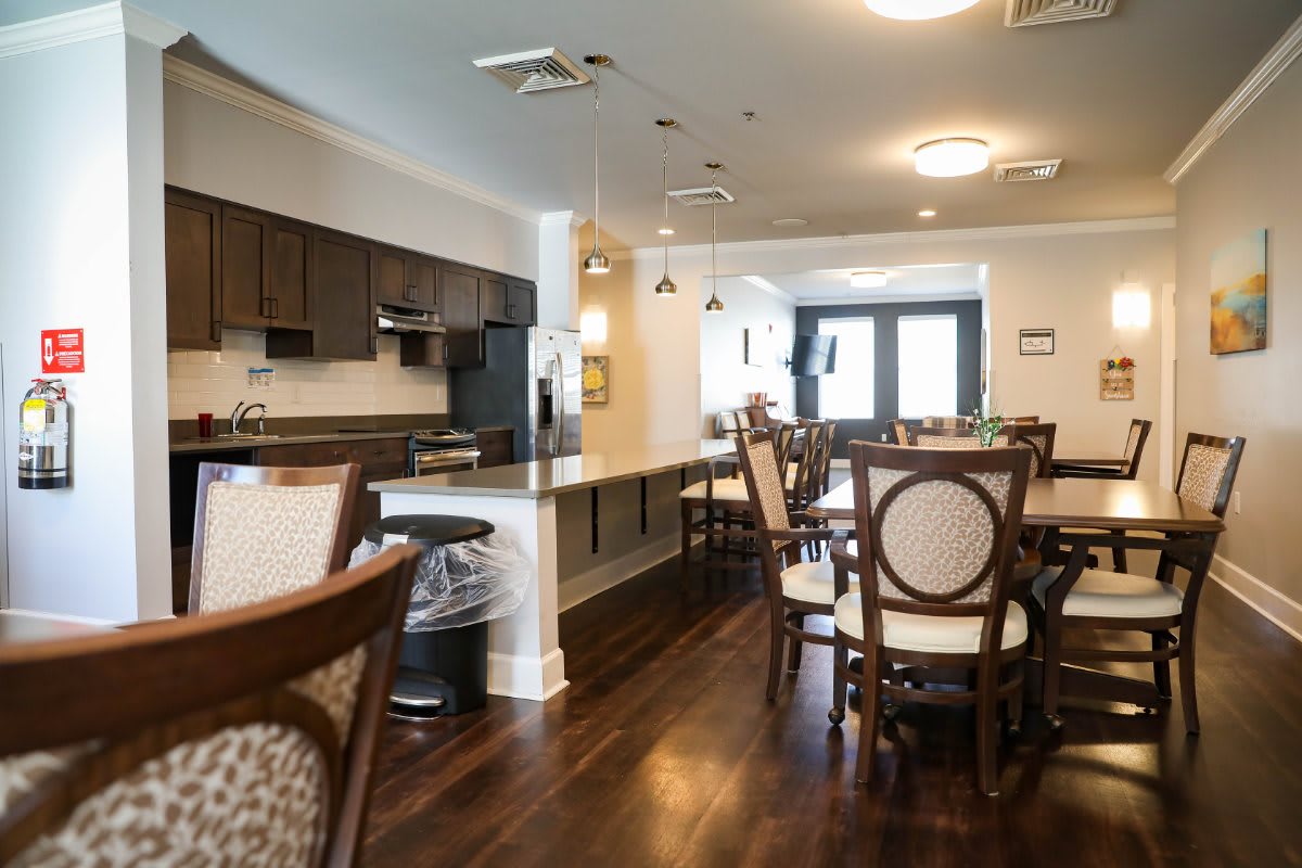 A modern kitchen and dining area with stylish wooden furniture and flooring.