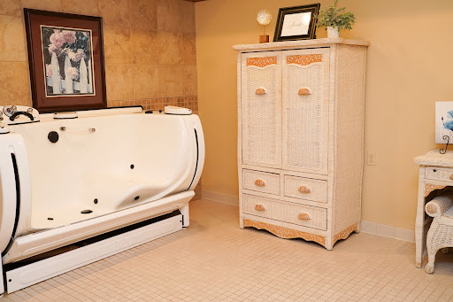 A serene bathroom featuring a modern bathtub and a stylish storage cabinet.