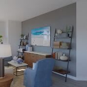 A modern living room with stylish shelving and wall art.