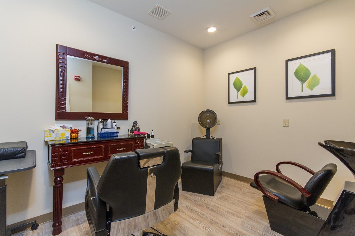 A well-organized hair salon with a cutting station and seating area.