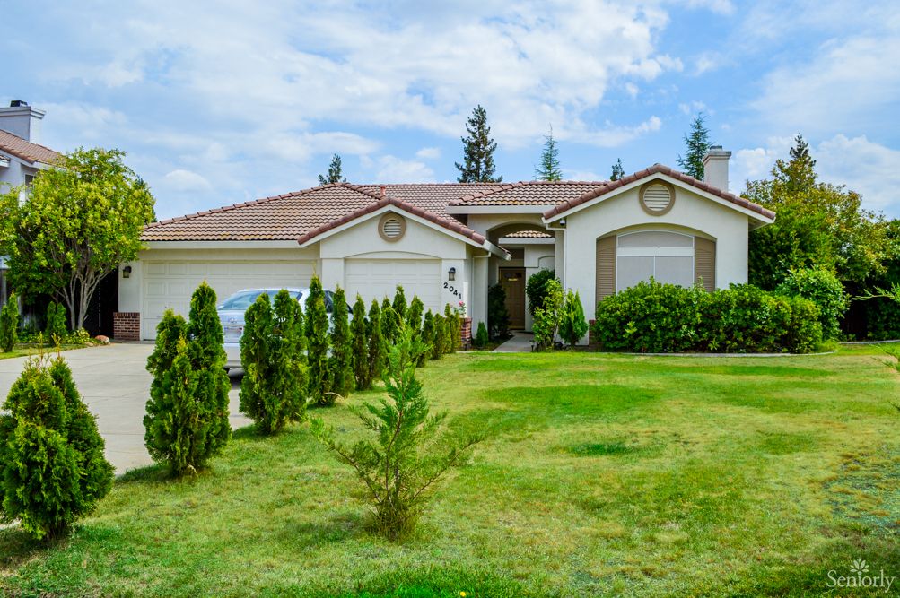 A suburban residential house with a well-maintained lawn and garden.