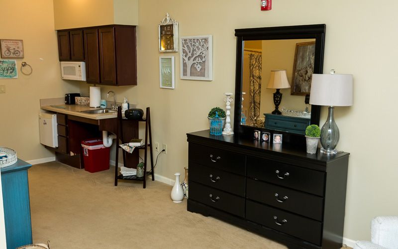 A cozy interior featuring a dresser with a mirror and home decor elements.