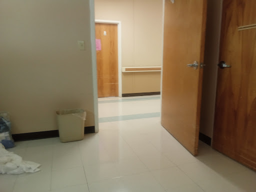 A view of a hallway with doors leading to different rooms.