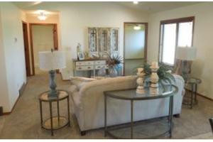 A cozy living room with a sofa, side tables, and decorative items.