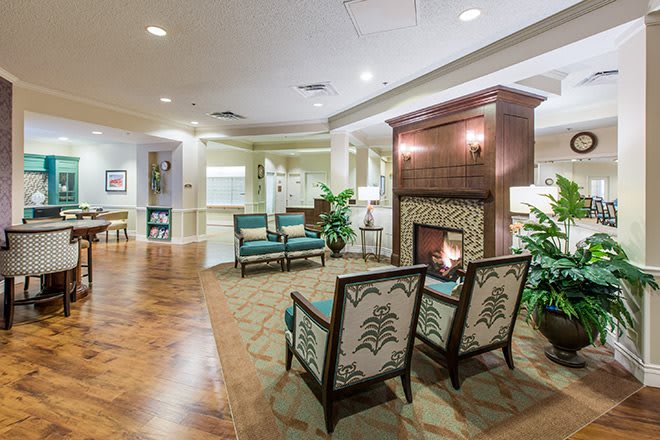A cozy interior seating area with a fireplace and comfortable chairs.