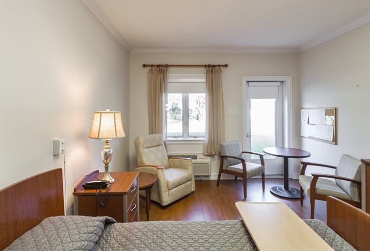 A cozy bedroom with comfortable seating and natural light.