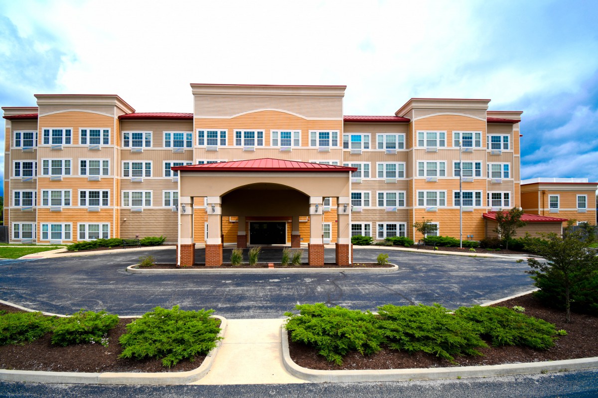 A modern hotel building with a welcoming entrance and well-maintained landscaping.