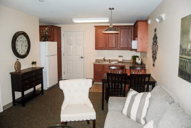 A compact apartment with an open kitchen and a cozy living area.
