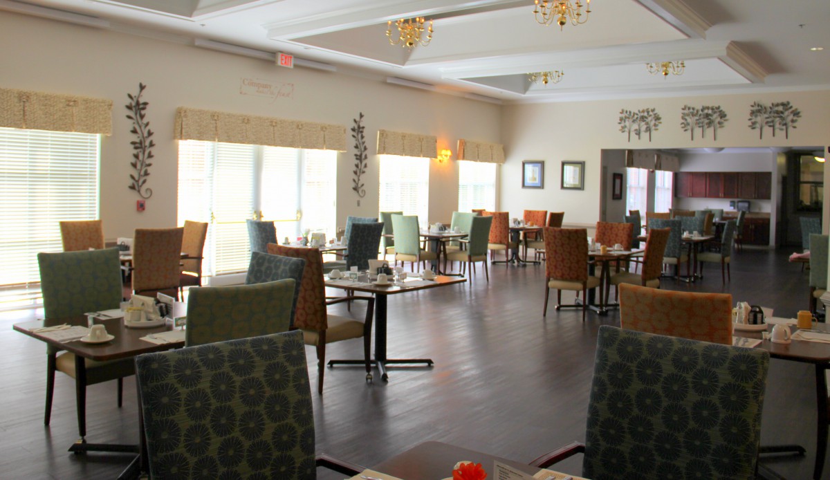 An empty dining area with modern decor and large windows.