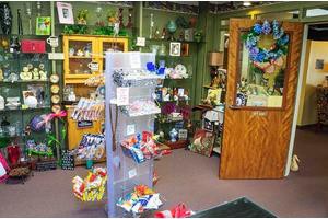 A cozy antique store featuring shelves stocked with vintage items and gifts.