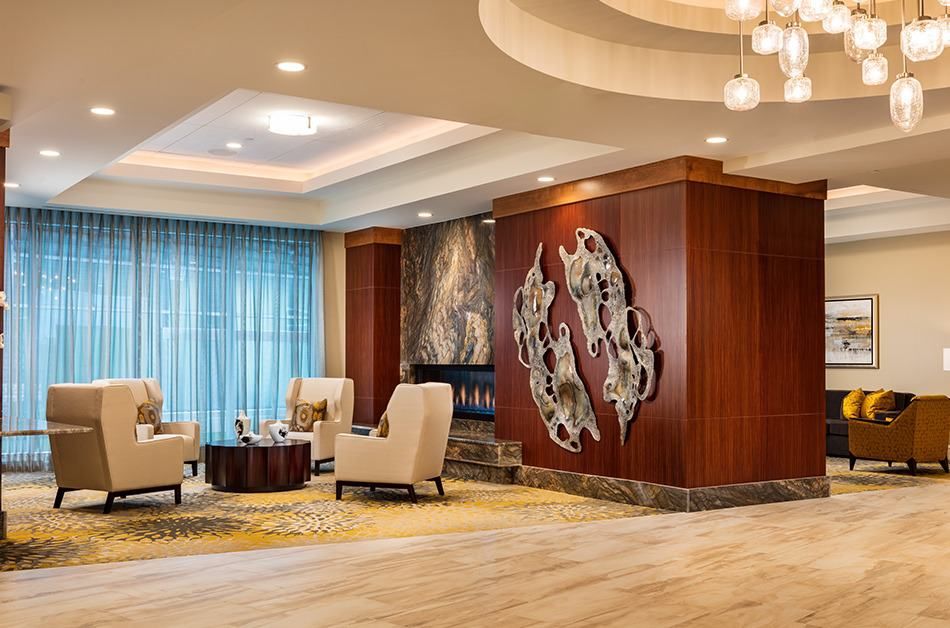 A modern hotel lobby featuring elegant seating and contemporary artwork.