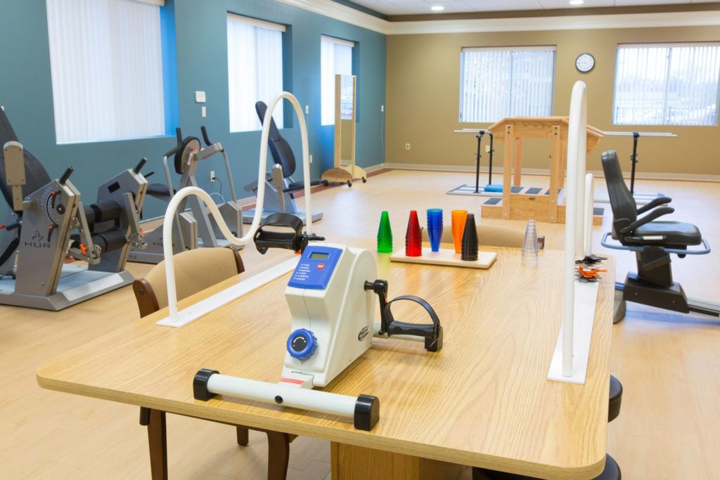 A rehabilitation room equipped with various physical therapy tools and exercise machines.