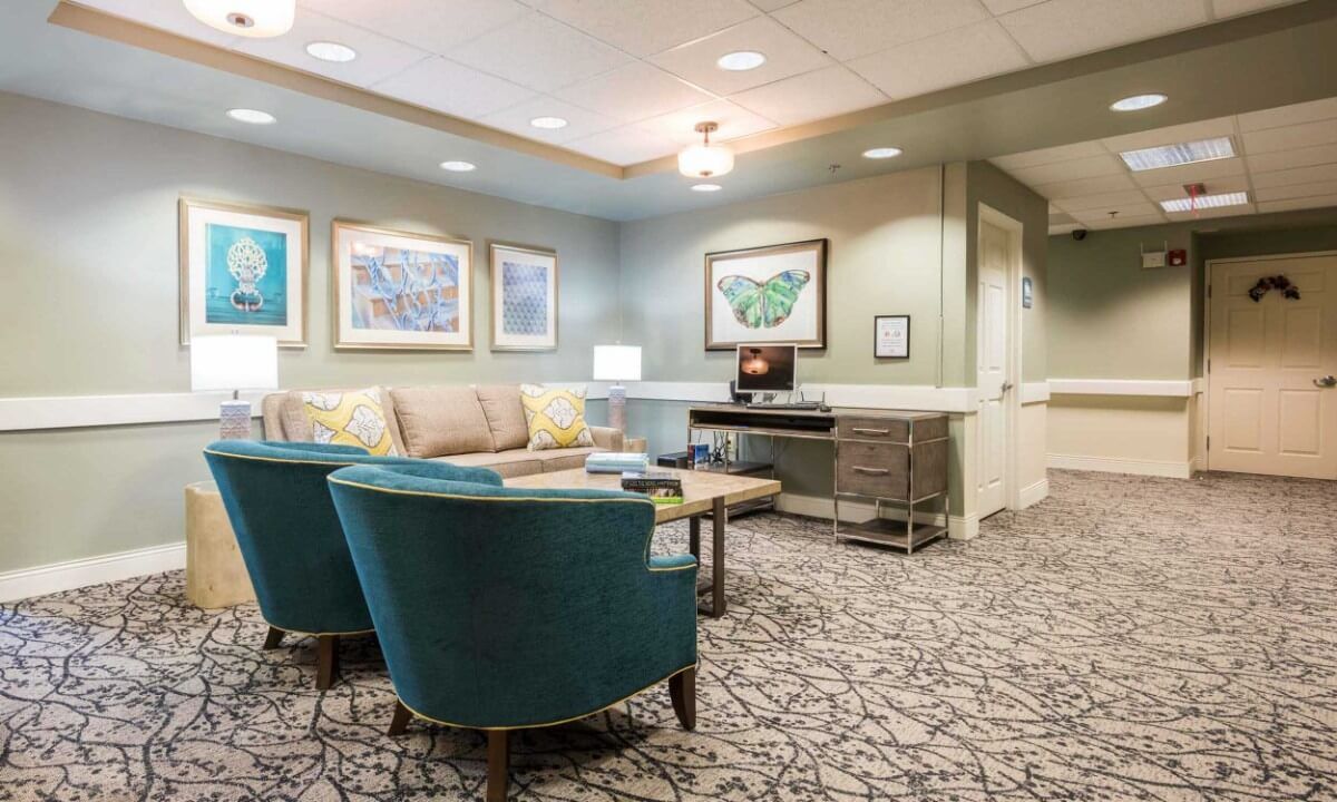 A cozy lounge area with comfortable seating and artwork on the walls.