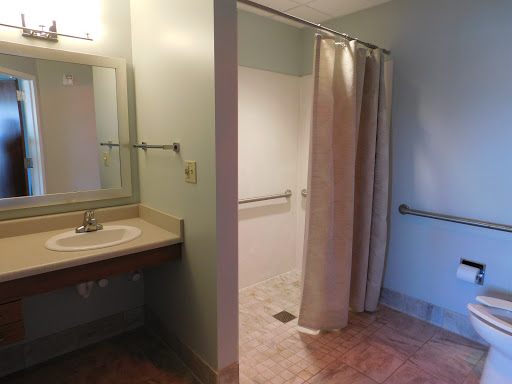A clean and accessible bathroom featuring a shower and vanity.