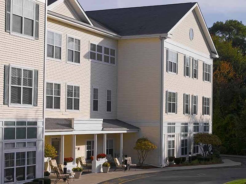A multi-story residential building with a clean architectural design and numerous windows.