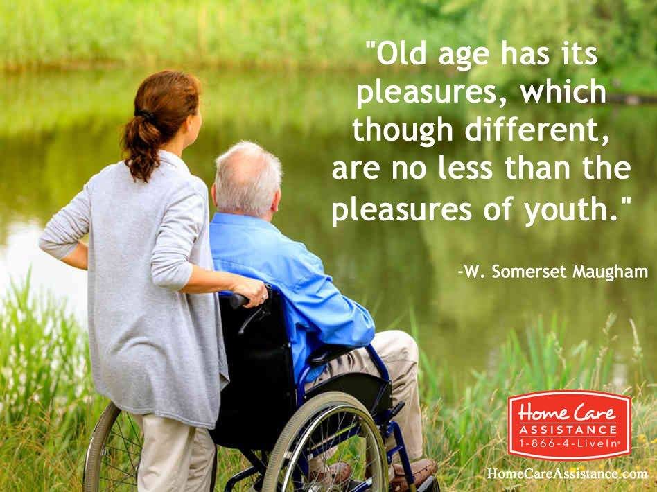 A caregiver and an elderly person in a wheelchair enjoy a serene outdoor scene, accompanied by a quote from W. Somerset Maugham about the pleasures of old age.