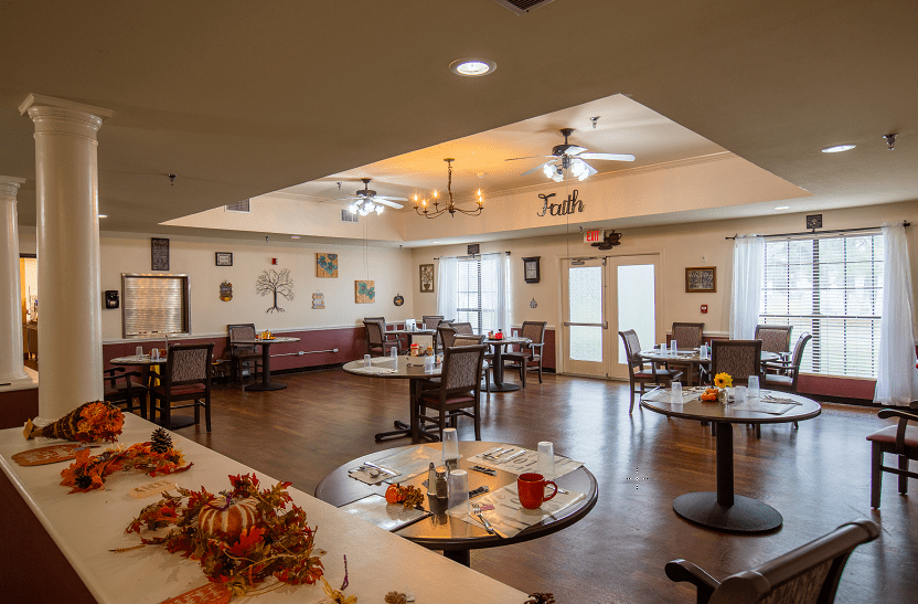 A cozy dining area with decorated tables and ample lighting.