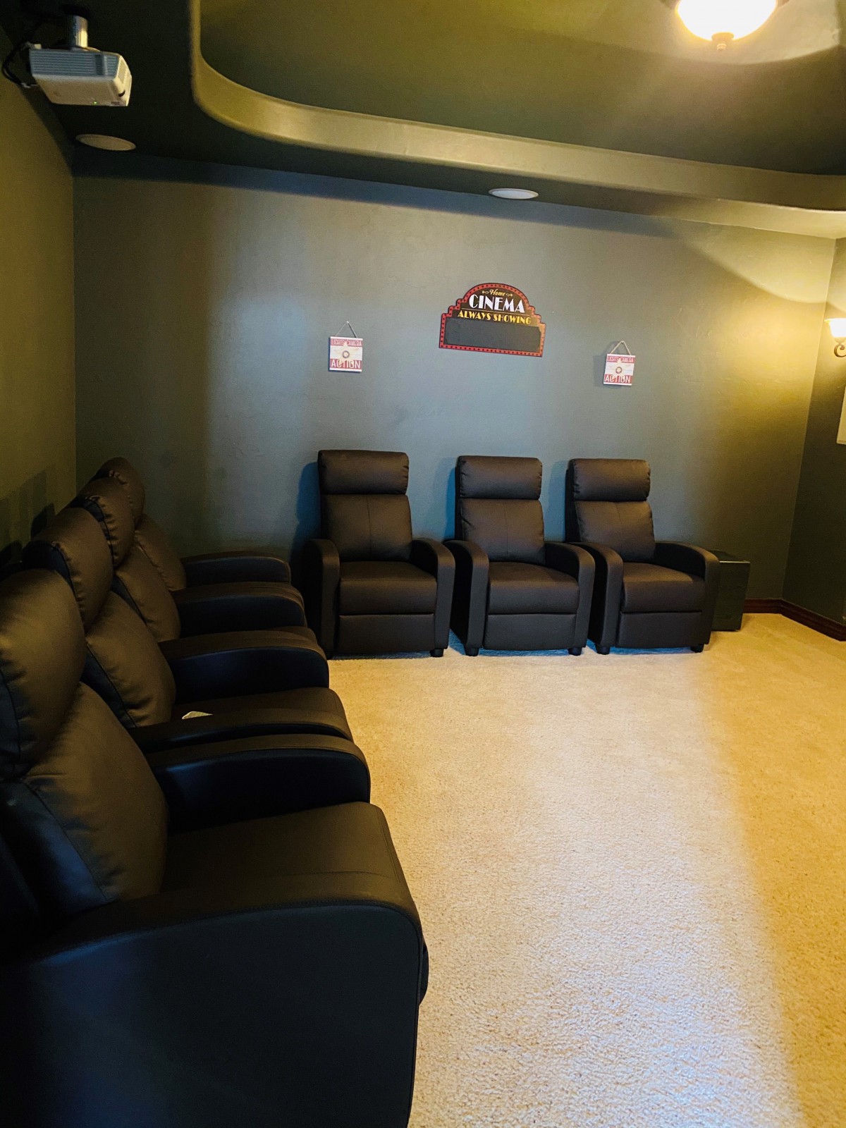 A cozy home theater room with comfortable recliner seating.