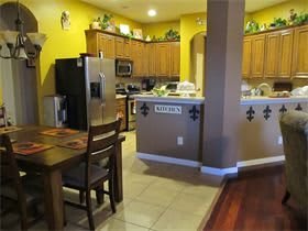 A cozy kitchen with wooden cabinets and a dining area.