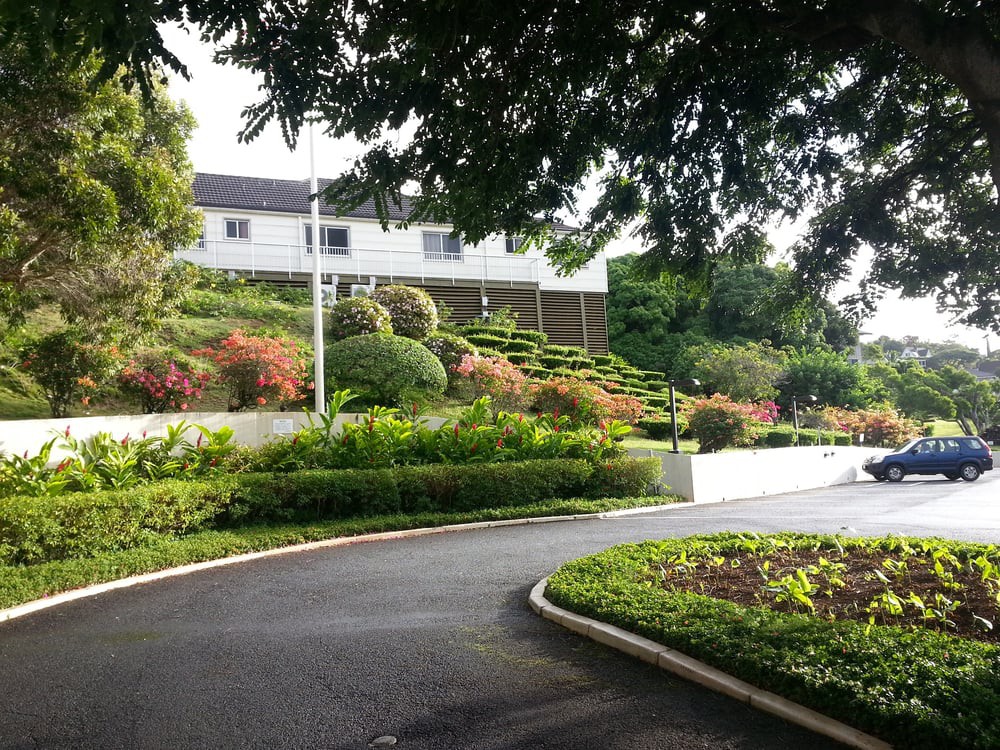 A scenic view of a landscaped garden with a winding pathway leading to a house.