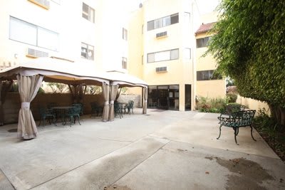 A residential courtyard with outdoor seating and canopies.