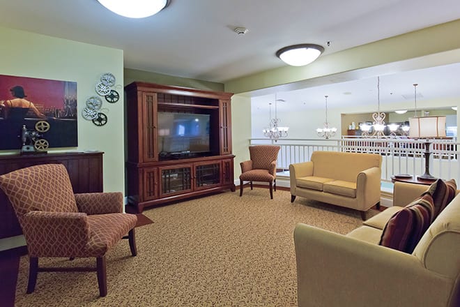 A modern living room with comfortable seating and a large television.