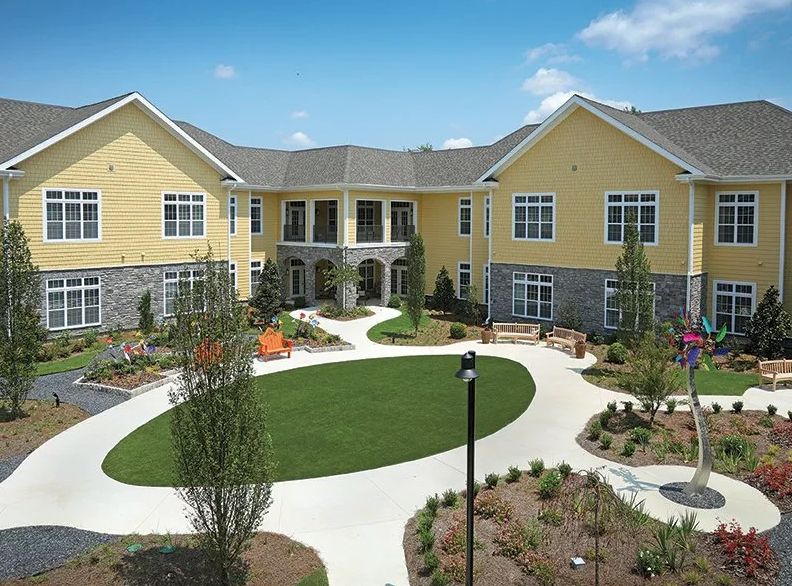 A modern residential building with a landscaped courtyard.