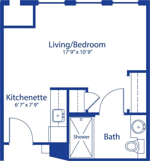 A floor plan of a studio apartment featuring a living/bedroom area, kitchenette, and bathroom.