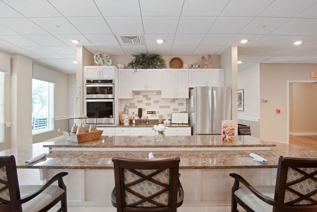 A modern kitchen with a stylish countertop, equipped with appliances and decorated with plants and accessories.