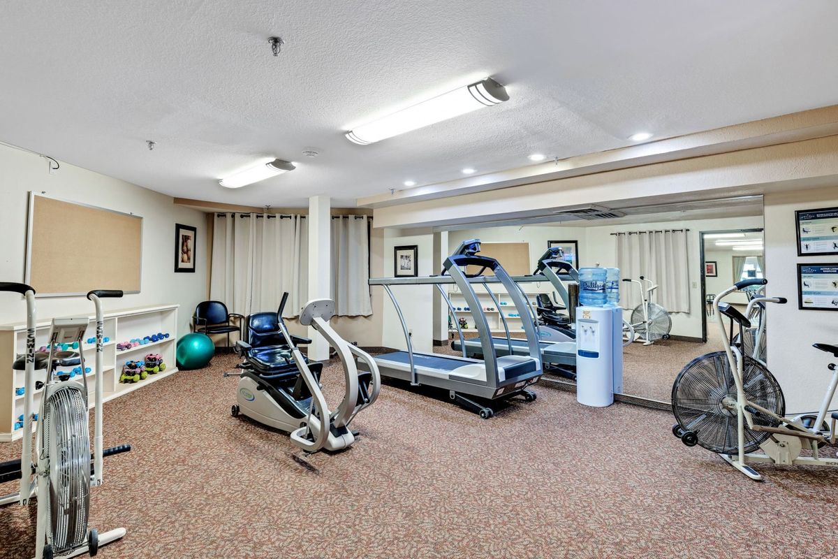 A small gym with exercise machines and fitness equipment.