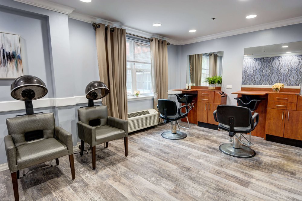 A modern hair salon interior with styling chairs and mirrors.