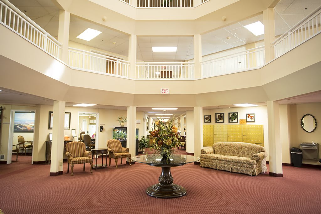A spacious lobby area featuring comfortable seating and decorative elements.