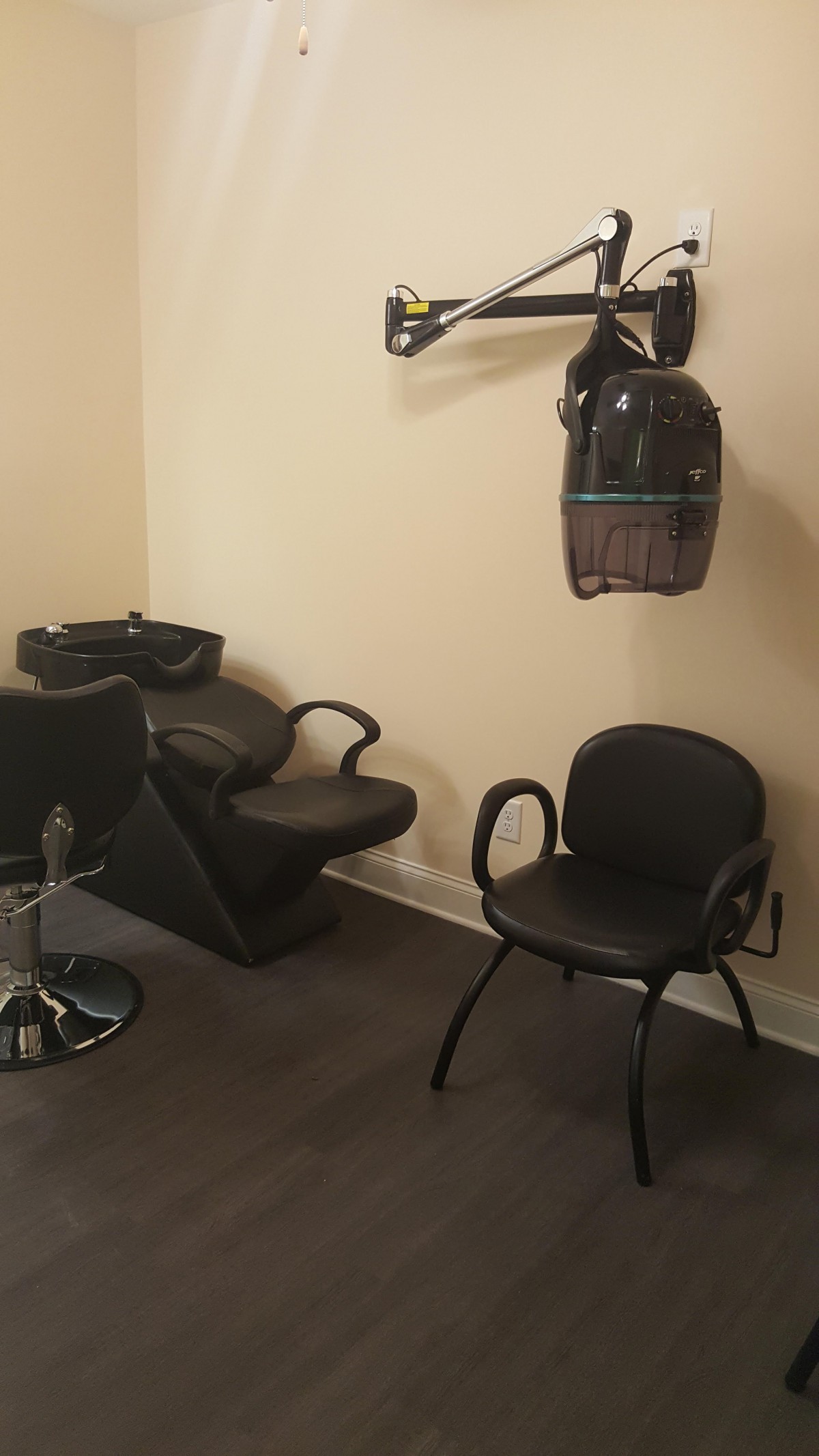 A cozy hair salon setup with a washing station and drying area.