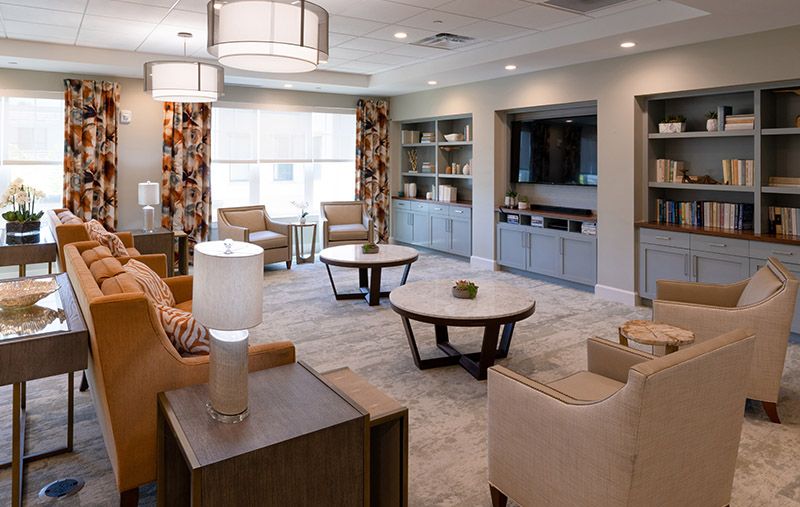 A modern living room with stylish furniture and decor, featuring comfortable seating and elegant lighting.