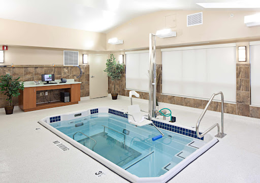 A serene indoor spa area featuring a jacuzzi, designed for relaxation and wellness treatments.