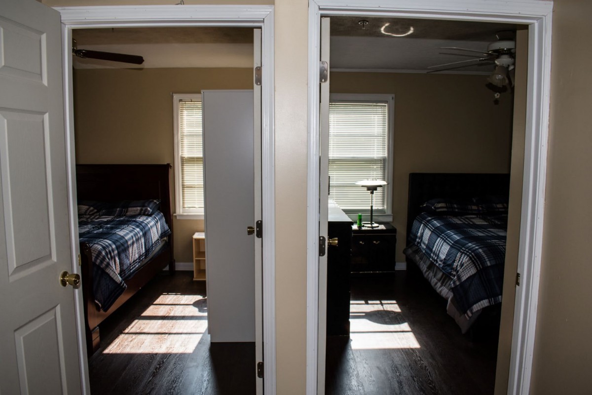 Two adjacent bedrooms with identical layouts and furniture, separated by a central wall.