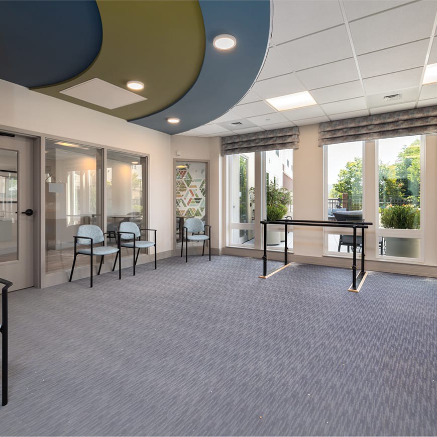 A modern, spacious interior with large windows and minimalistic furnishings.