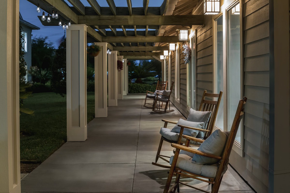 A welcoming porch with wooden rocking chairs and soft evening lighting.