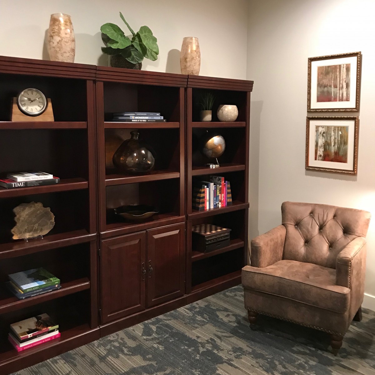 A cozy living room corner with a wooden bookshelf and a comfortable armchair.