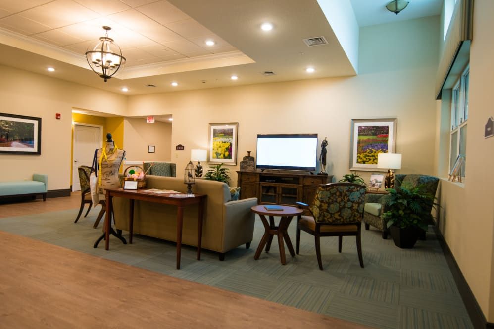 A cozy living room with comfortable seating and a large television.