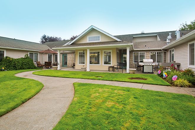 A charming single-story house with a well-maintained lawn and a welcoming front porch.