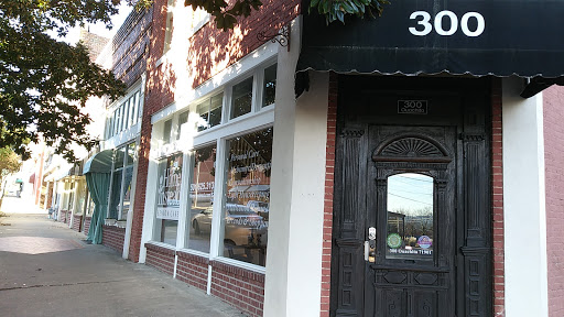 A charming brick storefront with large windows and a welcoming entrance.