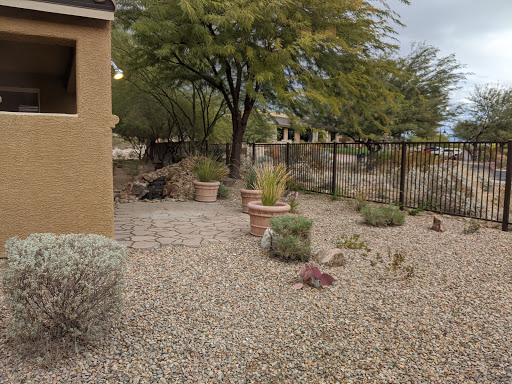 A serene outdoor garden space featuring gravel landscaping, various plants, and a cozy atmosphere.