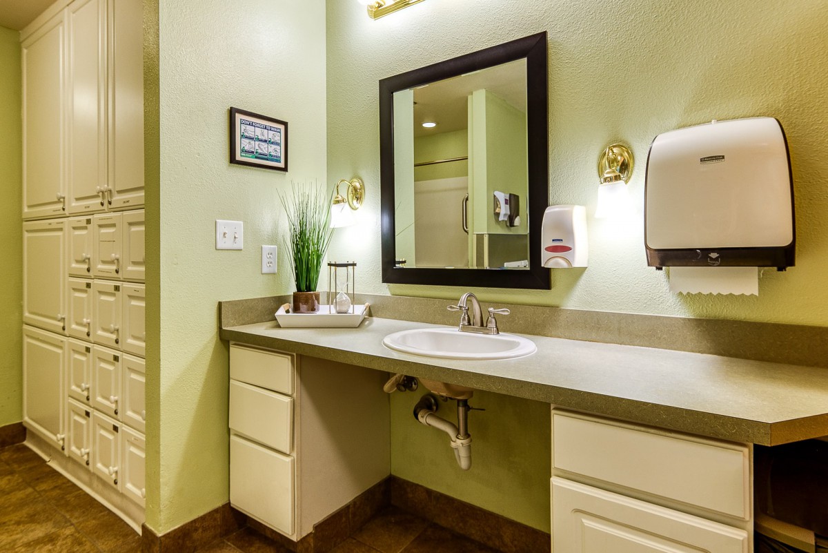 A well-decorated bathroom with a sink, mirror, and countertop.