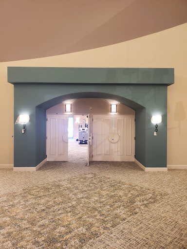 An elegant entrance featuring a blue archway and double doors, complemented by stylish wall sconces.