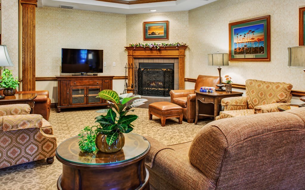 A cozy living room featuring a fireplace, comfortable seating, and modern decor.