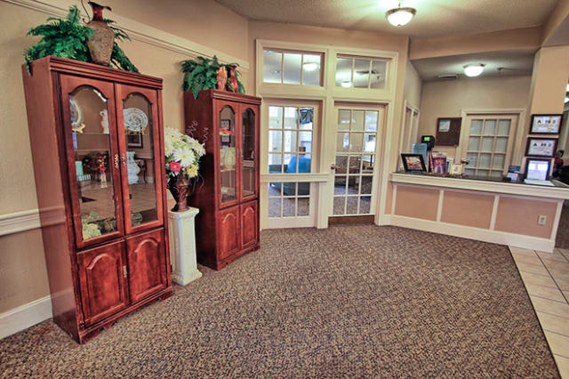 A welcoming reception area with display cabinets and cozy decor.