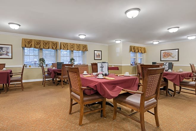 A cozy dining area with neatly arranged tables and chairs, set for service.