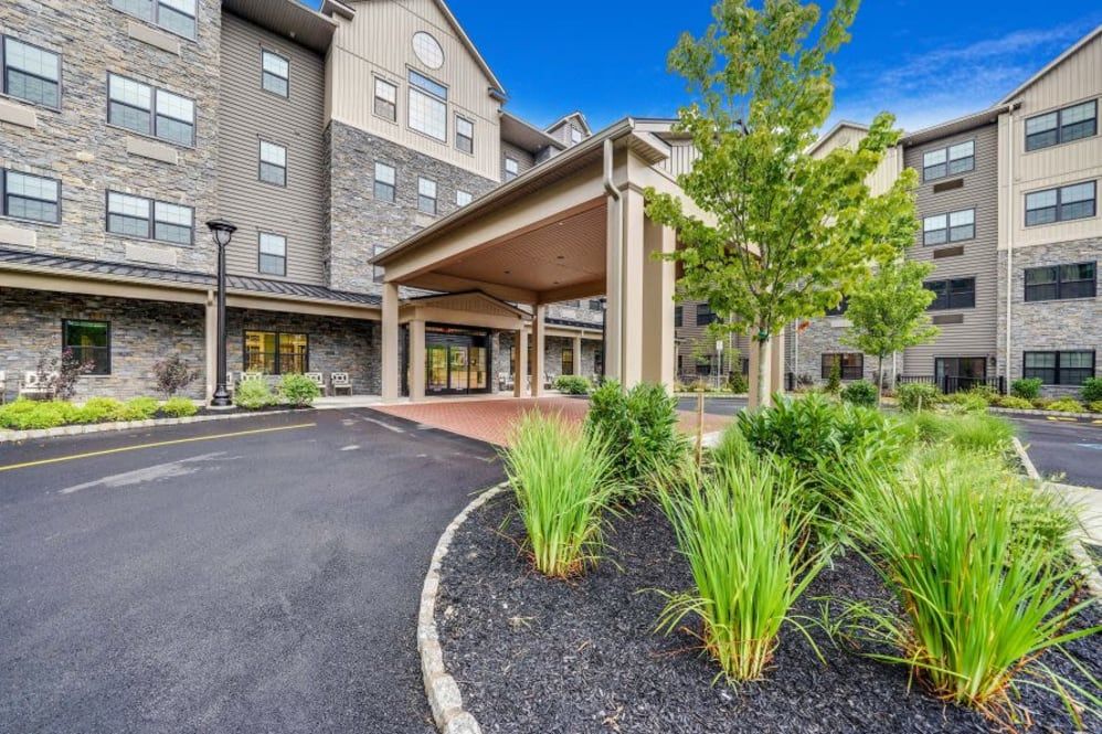 A hotel entrance with landscaped surroundings and a welcoming canopy.
